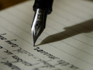 Photograph of a fountain pen writing on lined paper