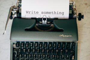 Typewriter with the words "Write something" shown on the paper